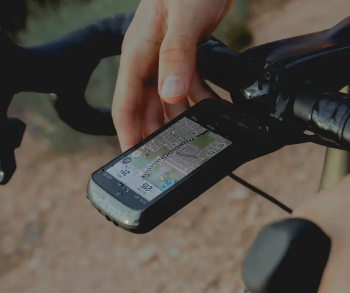 An ELEMNT ROAM bike computer on an out-front mount, its map on screen