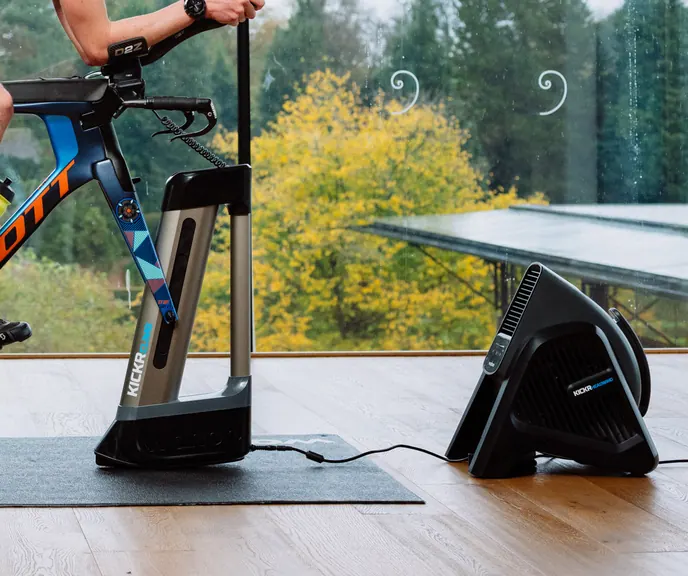 A bike on a KICKR trainer with a KICKR CLIMB and a KICKR HEADWIND fan beside it