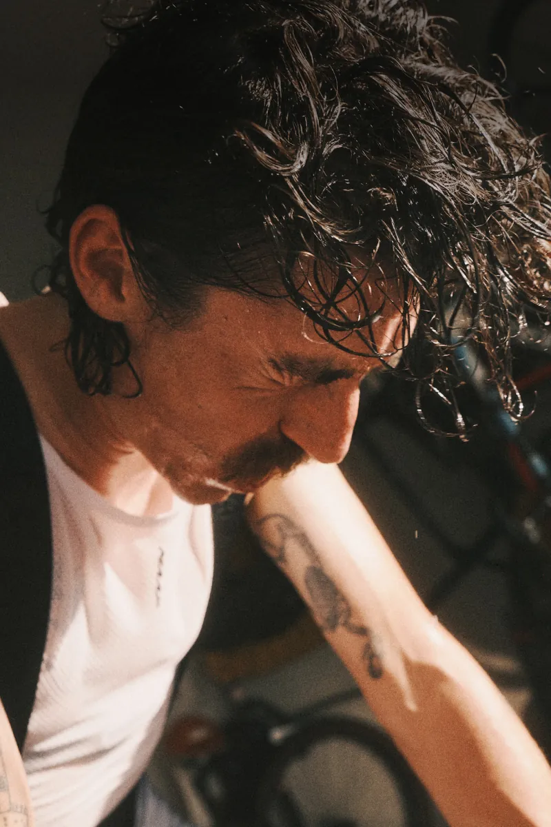 Sweaty cyclist focusing during an indoor workout