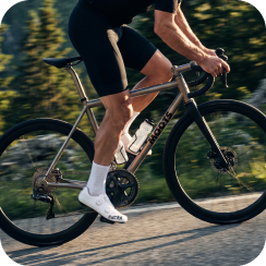 Cyclist riding on a road showcasing the precision power measurement of the pedals